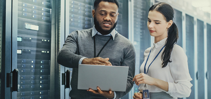 Ricoh Cloud & Infrastructure - man and woman standing in front of servers