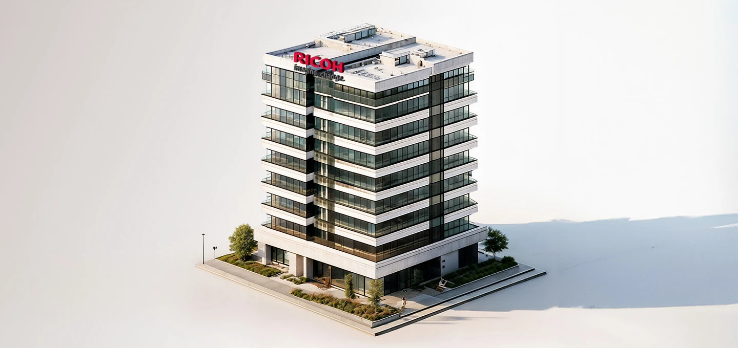 A miniature model of a modern, multi-story office building with the Ricoh logo prominently displayed.