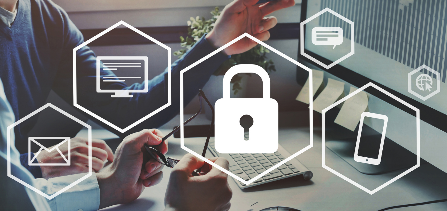 A digital security concept image showing hands gesturing near a computer, with overlay icons of a padlock, email, chat, and devices, indicating cybersecurity.